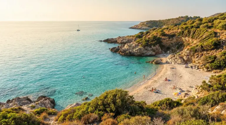 Spiaggia tranquilla con mare cristallino e poche persone sulla sabbia in una baia italiana